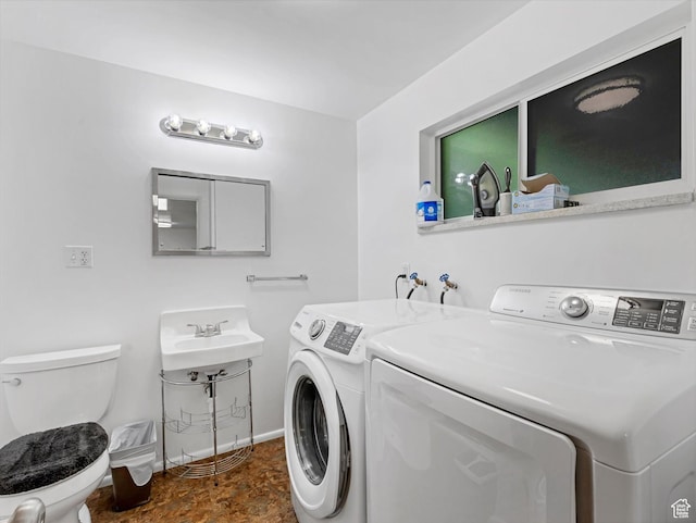 7645 W Gardenia Ave, Magna, UT 84044 - laundry area with washing machine and clothes dryer and baseboards