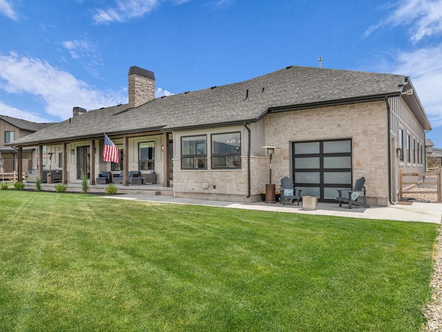 943 Hart Loop, Francis, UT 84036 - back of property featuring stone siding, a chimney, a patio area, and a lawn