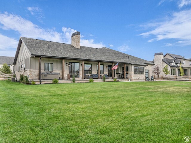 943 Hart Loop, Francis, UT 84036 - rear view of house featuring a chimney, stone siding, a patio area, and roof with shingles