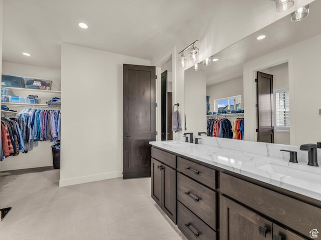 943 Hart Loop, Francis, UT 84036 - bathroom featuring double vanity, a spacious closet, and recessed lighting