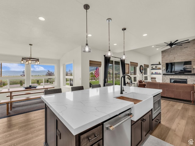 943 Hart Loop, Francis, UT 84036 - kitchen featuring stainless steel dishwasher, lofted ceiling, light wood-style flooring, a fireplace, and recessed lighting