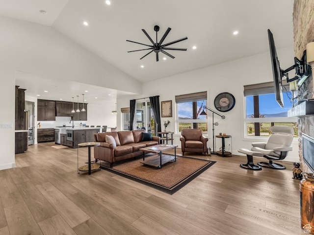 943 Hart Loop, Francis, UT 84036 - living area with recessed lighting, light wood-style flooring, a glass covered fireplace, and high vaulted ceiling