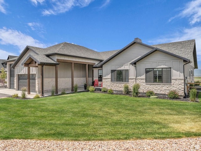 943 Hart Loop, Francis, UT 84036 - view of front facade featuring board and batten siding, a shingled roof, a front yard, a garage, and stone siding