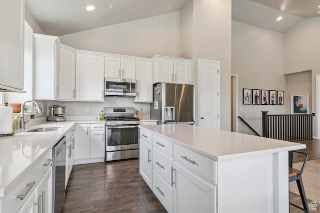 1820 W 950 N, Layton, UT 84041 - kitchen with appliances with stainless steel finishes, high vaulted ceiling, dark wood-style floors, a kitchen island, and white cabinetry