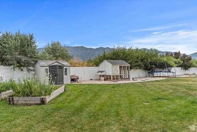 1820 W 950 N, Layton, UT 84041 - fenced backyard featuring a trampoline, a storage unit, a vegetable garden, and a mountain view