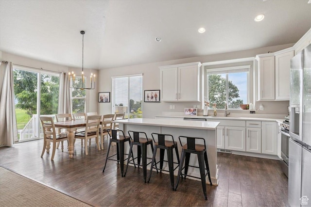 1820 W 950 N, Layton, UT 84041 - kitchen featuring a chandelier, light countertops, white cabinetry, a kitchen island, and dark wood-type flooring