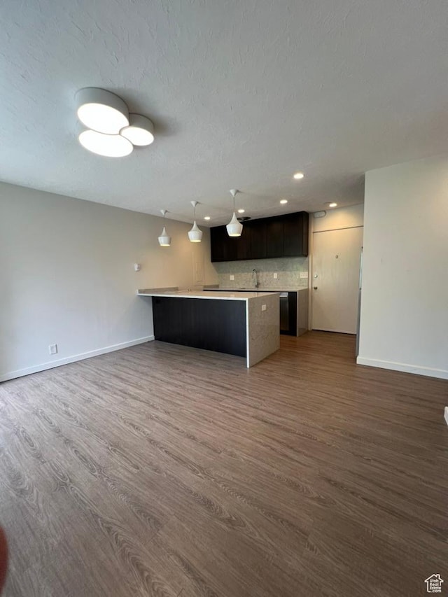 130 S 1300 E Unit 101, Salt Lake City, UT 84102 - kitchen featuring open floor plan, dark wood finished floors, light countertops, dark brown cabinetry, and recessed lighting