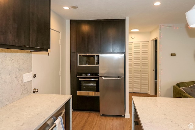 130 S 1300 E Unit 101, Salt Lake City, UT 84102 - kitchen with stainless steel appliances, light wood finished floors, dark brown cabinetry, recessed lighting, and modern cabinets