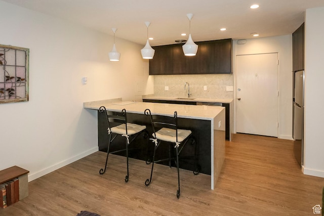 130 S 1300 E Unit 101, Salt Lake City, UT 84102 - bar area with backsplash, light wood-style floors, recessed lighting, and decorative light fixtures