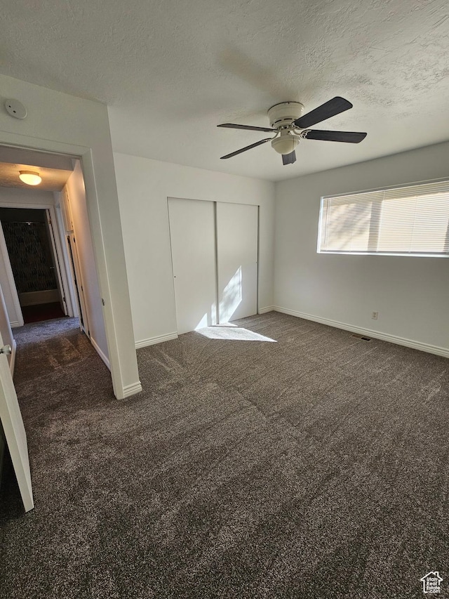 3673 S 2200 W Unit 15, West Valley City, UT 84119 - unfurnished bedroom with dark carpet, a closet, a textured ceiling, and ceiling fan