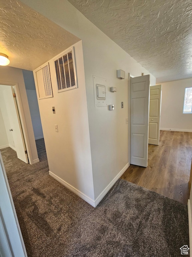 3673 S 2200 W Unit 15, West Valley City, UT 84119 - hallway featuring a textured ceiling, carpet flooring, and wood finished floors