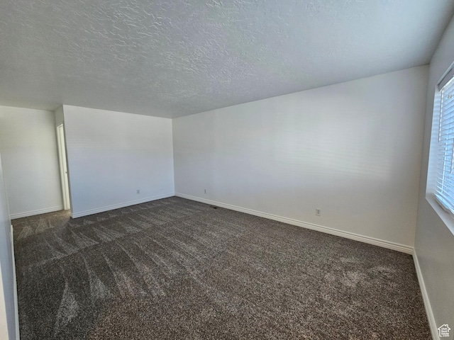 3673 S 2200 W Unit 15, West Valley City, UT 84119 - spare room featuring dark carpet and a textured ceiling