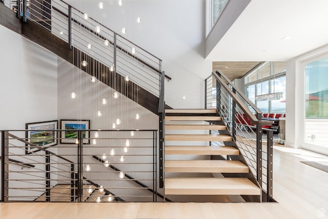 1433 Snow Berry St, Park City, UT 84098 - stairway featuring a towering ceiling and wood finished floors