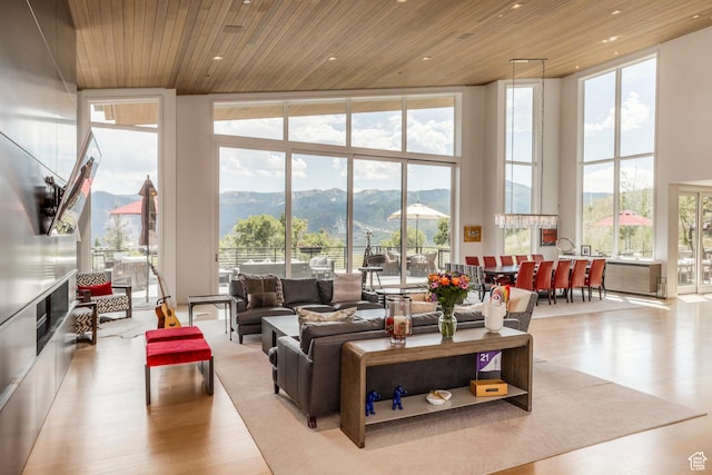 1433 Snow Berry St, Park City, UT 84098 - living area featuring expansive windows, a mountain view, wood finished floors, a towering ceiling, and wood ceiling