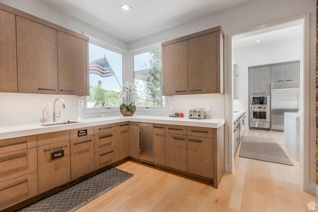 1433 Snow Berry St, Park City, UT 84098 - kitchen featuring built in appliances, light wood-style flooring, tasteful backsplash, light countertops, and recessed lighting