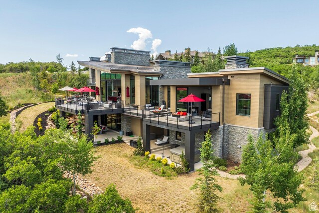 1433 Snow Berry St, Park City, UT 84098 - back of property with stone siding, a chimney, a deck, and a patio