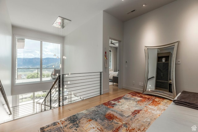1433 Snow Berry St, Park City, UT 84098 - hallway with an upstairs landing, wood finished floors, a mountain view, and a skylight