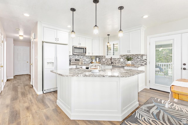378 N 1180 E, Pleasant Grove, UT 84062 - kitchen with appliances with stainless steel finishes, decorative backsplash, white cabinetry, a center island, and recessed lighting