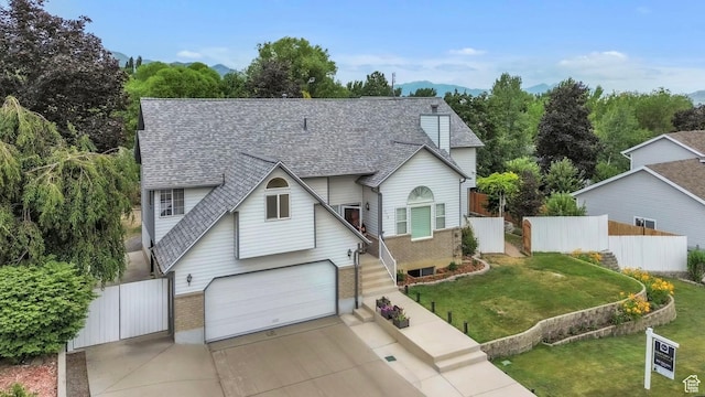378 N 1180 E, Pleasant Grove, UT 84062 - traditional home with a shingled roof, brick siding, a garage, driveway, and a gate