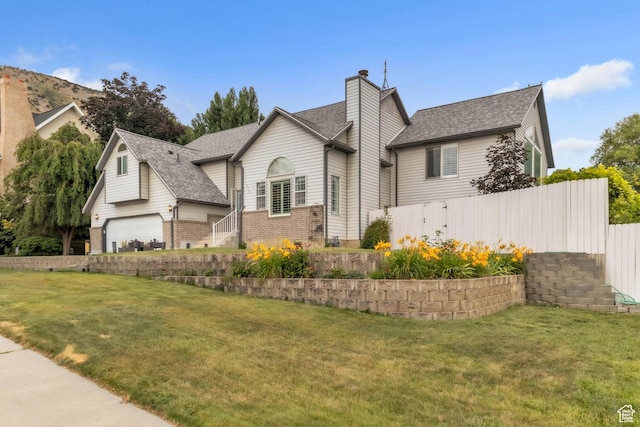 378 N 1180 E, Pleasant Grove, UT 84062 - view of front of house featuring brick siding, a chimney, a shingled roof, and a garage