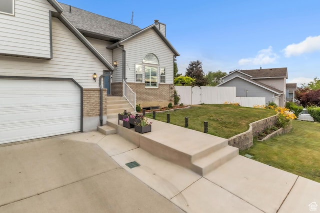 378 N 1180 E, Pleasant Grove, UT 84062 - view of front of house with driveway, a garage, a chimney, and brick siding