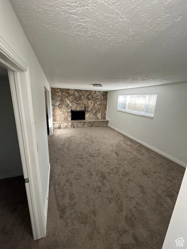290 S 300 E, Orem, UT 84058 - unfurnished living room featuring carpet flooring, a textured ceiling, and a fireplace