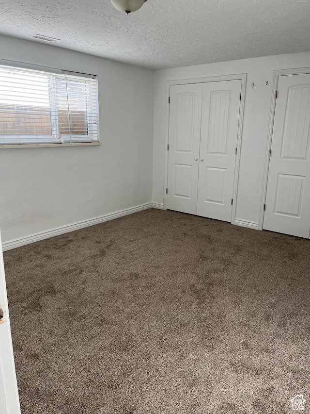 290 S 300 E, Orem, UT 84058 - unfurnished bedroom with carpet floors, a textured ceiling, and a closet