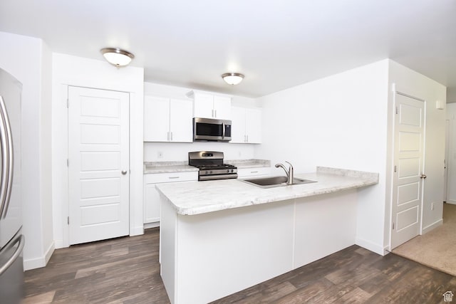 5063 W Arete Way, Herriman, UT 84096 - kitchen with appliances with stainless steel finishes, dark wood finished floors, a peninsula, light countertops, and white cabinets