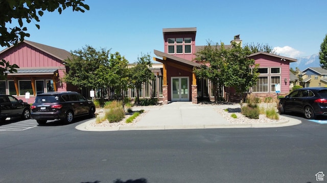 5063 W Arete Way, Herriman, UT 84096 - craftsman-style house with french doors, board and batten siding, a chimney, and stone siding