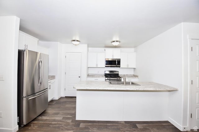 5063 W Arete Way, Herriman, UT 84096 - kitchen with appliances with stainless steel finishes, a peninsula, light stone countertops, dark wood-style floors, and white cabinetry