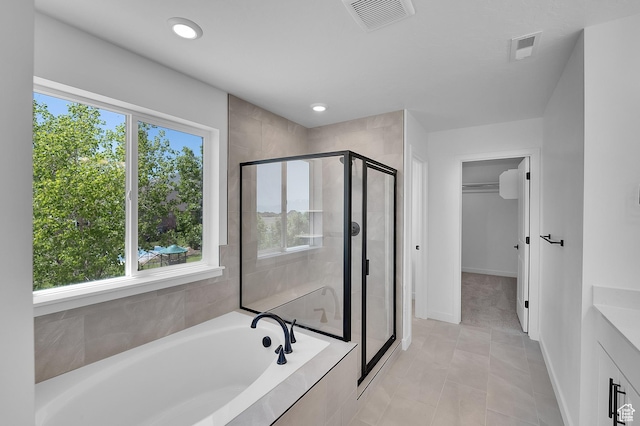 3362 S Zigzag Heron Dr Unit 813, Saratoga Springs, UT 84045 - bathroom featuring a shower stall, a garden tub, a spacious closet, vanity, and recessed lighting
