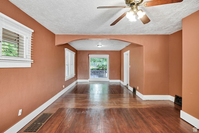 420 E 400 N, Logan, UT 84321 - spare room featuring arched walkways, a textured ceiling, ceiling fan, and wood-type flooring