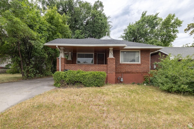 420 E 400 N, Logan, UT 84321 - view of front of home with a front lawn, brick siding, and driveway
