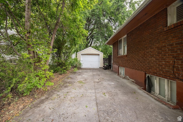 420 E 400 N, Logan, UT 84321 - view of home's exterior with concrete driveway, a garage, an outbuilding, and brick siding