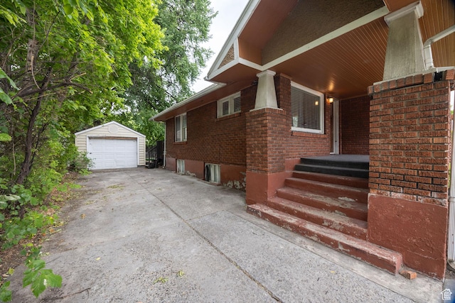 420 E 400 N, Logan, UT 84321 - view of home's exterior featuring driveway, a garage, brick siding, and an outbuilding