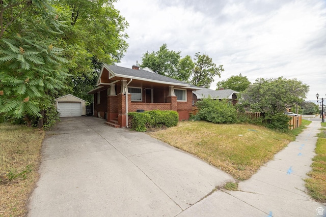 420 E 400 N, Logan, UT 84321 - view of front of property with brick siding, an outbuilding, a front yard, a chimney, and a detached garage