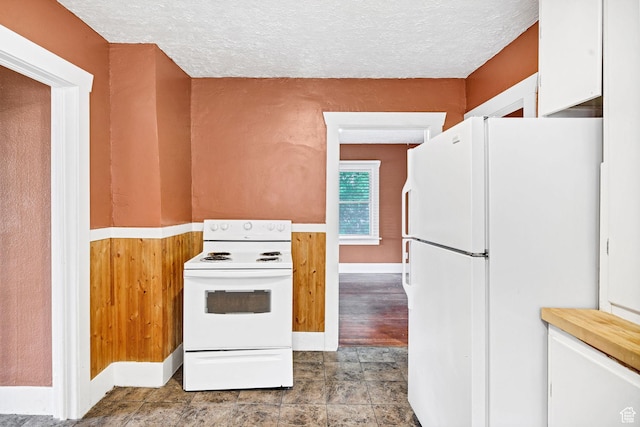 420 E 400 N, Logan, UT 84321 - kitchen with white appliances, a textured ceiling, white cabinetry, and light countertops