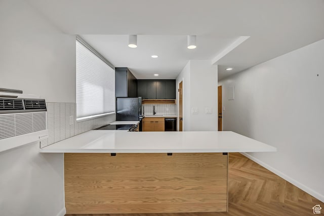 673 E 6th Ave, Salt Lake City, UT 84103 - kitchen featuring freestanding refrigerator, a kitchen bar, light countertops, a peninsula, and decorative backsplash