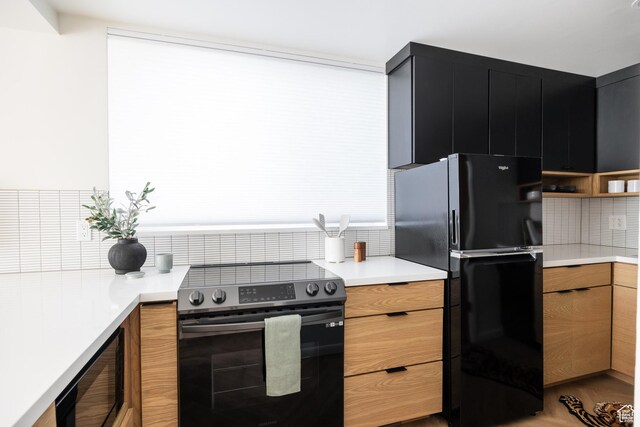 673 E 6th Ave, Salt Lake City, UT 84103 - kitchen with stainless steel range with electric stovetop, freestanding refrigerator, and tasteful backsplash
