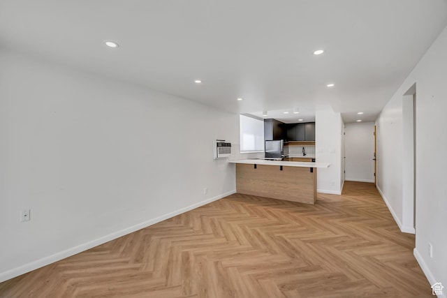 673 E 6th Ave, Salt Lake City, UT 84103 - kitchen with a breakfast bar area, light countertops, a peninsula, freestanding refrigerator, and recessed lighting