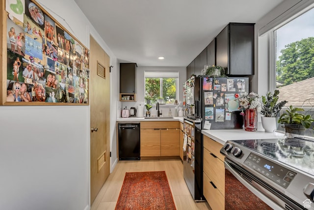 673 E 6th Ave, Salt Lake City, UT 84103 - kitchen with black appliances, light countertops, recessed lighting, dark cabinetry, and light brown cabinetry