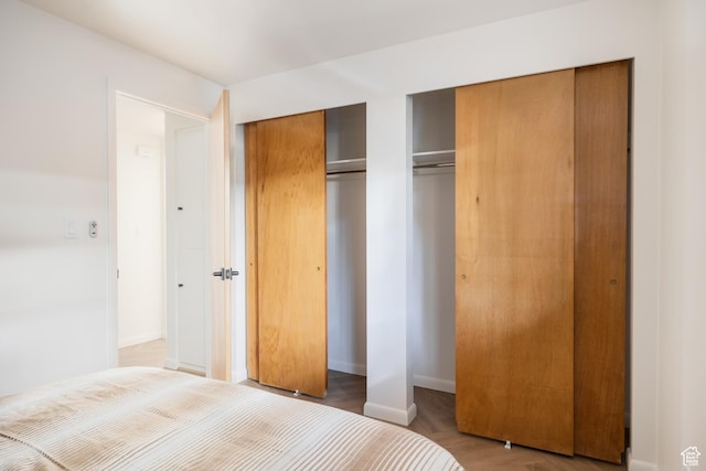 673 E 6th Ave, Salt Lake City, UT 84103 - unfurnished bedroom with two closets and wood finished floors