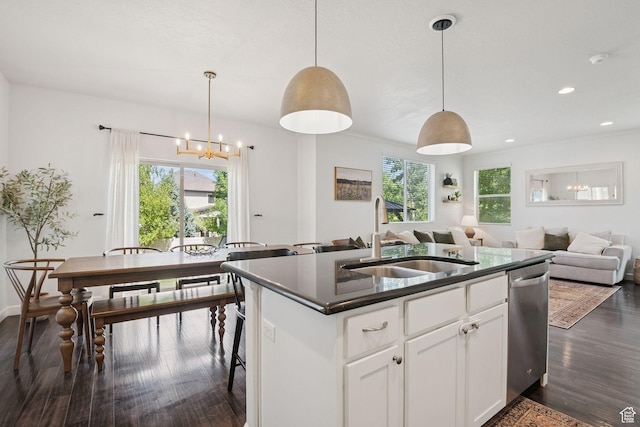 13159 S Herriman Rose Blvd, Herriman, UT 84096 - kitchen featuring dishwasher, dark wood-type flooring, dark countertops, a kitchen island with sink, and recessed lighting