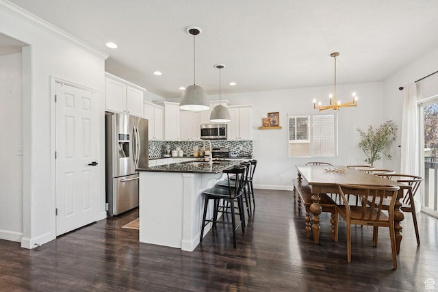13159 S Herriman Rose Blvd, Herriman, UT 84096 - kitchen featuring stainless steel appliances, dark countertops, tasteful backsplash, dark wood-style flooring, and recessed lighting
