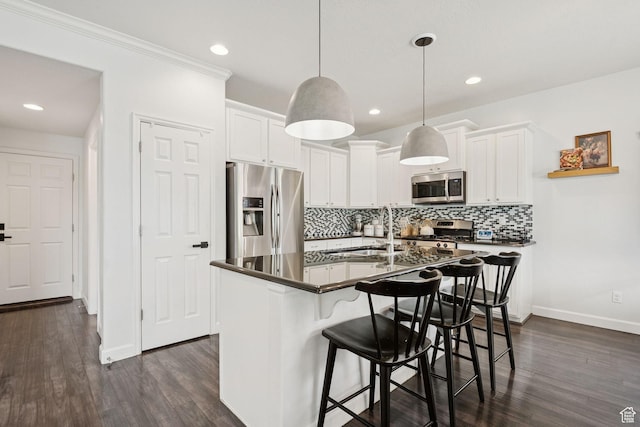 13159 S Herriman Rose Blvd, Herriman, UT 84096 - kitchen featuring appliances with stainless steel finishes, dark countertops, dark wood-style floors, backsplash, and recessed lighting