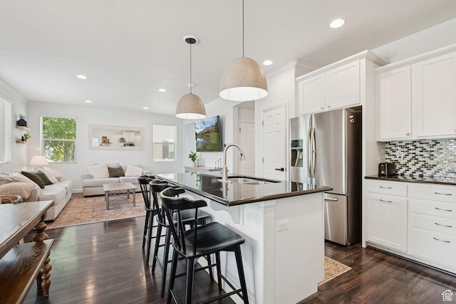 13159 S Herriman Rose Blvd, Herriman, UT 84096 - kitchen featuring dark countertops, stainless steel fridge with ice dispenser, open floor plan, recessed lighting, and a kitchen bar