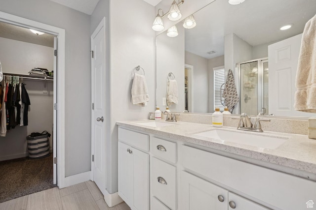 13159 S Herriman Rose Blvd, Herriman, UT 84096 - bathroom with a stall shower, double vanity, and a spacious closet