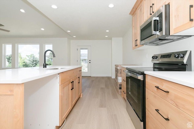 821 E 160 N, Hyde Park, UT 84318 - kitchen featuring appliances with stainless steel finishes, light brown cabinetry, light wood-style flooring, recessed lighting, and light countertops