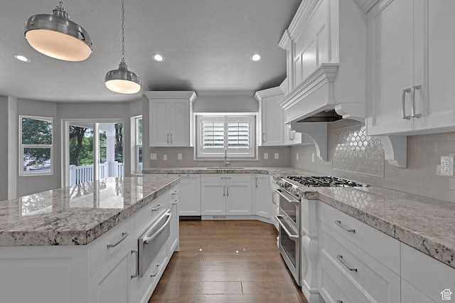 5575 S 1350 E, South Ogden, UT 84403 - kitchen with range with two ovens, a warming drawer, recessed lighting, white cabinetry, and tasteful backsplash
