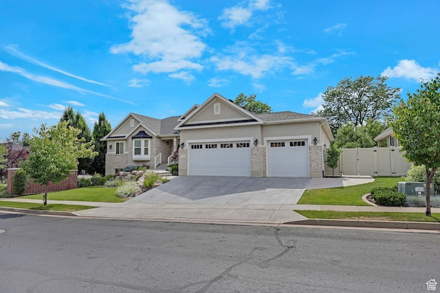 5575 S 1350 E, South Ogden, UT 84403 - view of front of house featuring a garage, stucco siding, concrete driveway, stone siding, and a gate